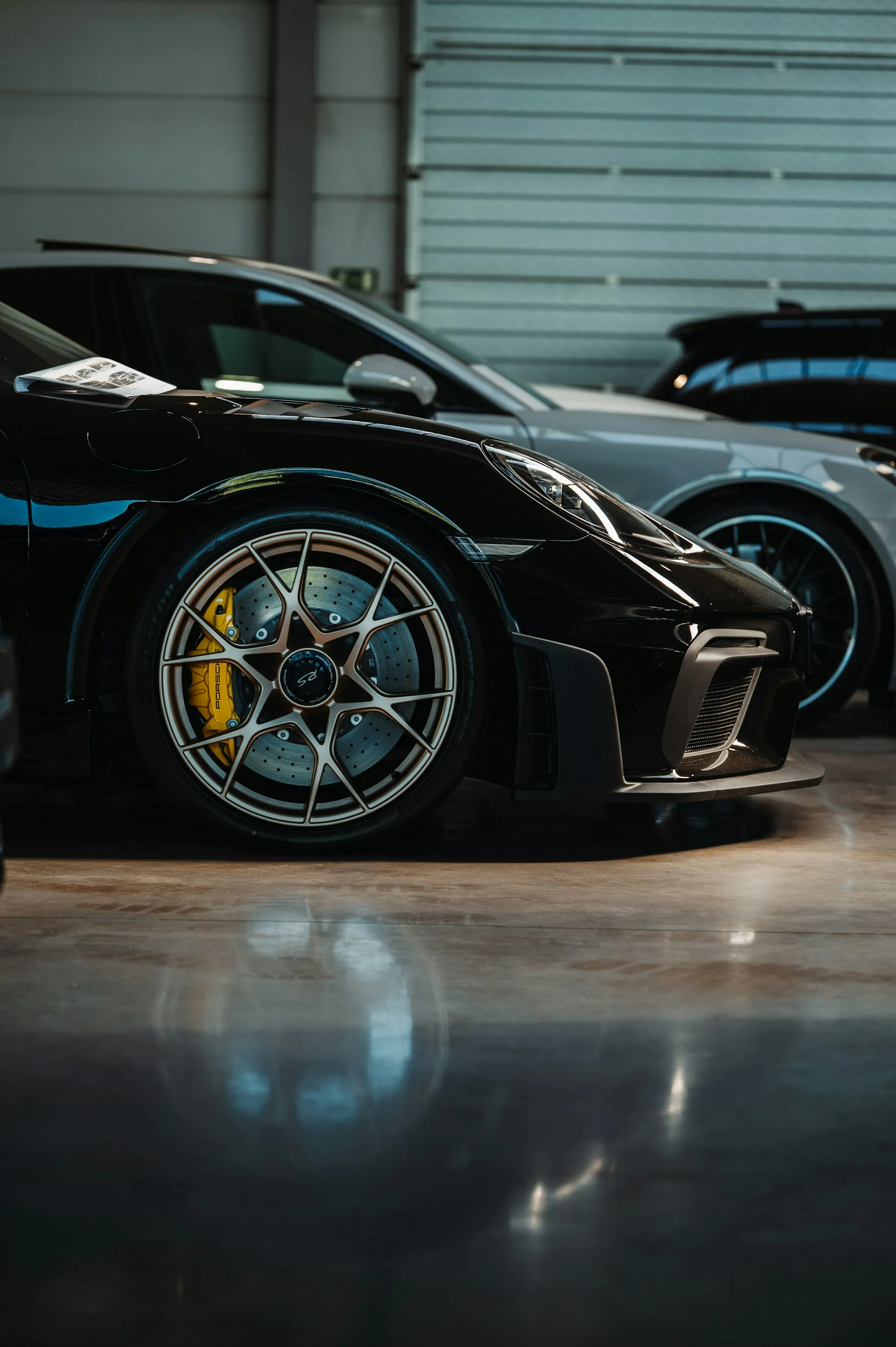 Black sports car on a black and silver metallic epoxy garage floor